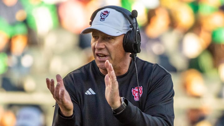 Oct 11, 2025; South Bend, Indiana, USA; NC State Wolfpack head coach Dave Doeren claps as he walks onto the field against the Notre Dame Fighting Irish during the second half at Notre Dame Stadium. Mandatory Credit: Michael Caterina-Imagn Images