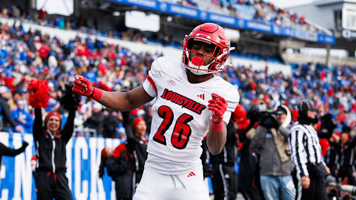 Nov 30, 2024; Lexington, Kentucky, USA; Louisville Cardinals running back Duke Watson (26) celebrates in the end zone after scoring a touchdown during the third quarter against the Kentucky Wildcats at Kroger Field. Mandatory Credit: Jordan Prather-Imagn Images