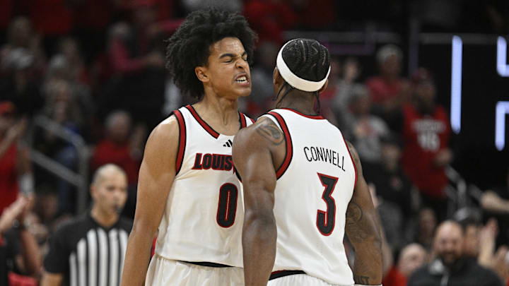 Nov 11, 2025; Louisville, Kentucky, USA;  Louisville Cardinals guard Mikel Brown Jr. (0) and guard Ryan Conwell (3) celebrate during the first half against the Kentucky Wildcats at KFC Yum! Center. Mandatory Credit: Jamie Rhodes-Imagn Images