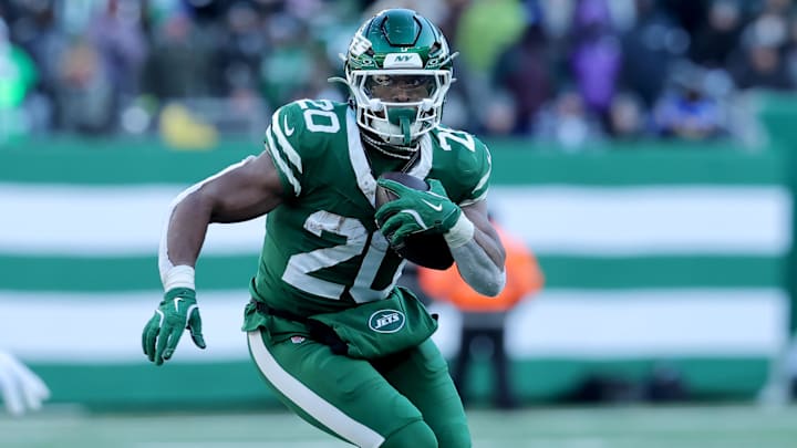 Dec 22, 2024; East Rutherford, New Jersey, USA; New York Jets running back Breece Hall (20) runs with the ball against the Los Angeles Rams during the second quarter at MetLife Stadium. 