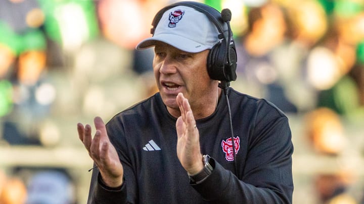 Oct 11, 2025; South Bend, Indiana, USA; NC State Wolfpack head coach Dave Doeren claps as he walks onto the field against the Notre Dame Fighting Irish during the second half at Notre Dame Stadium. Mandatory Credit: Michael Caterina-Imagn Images