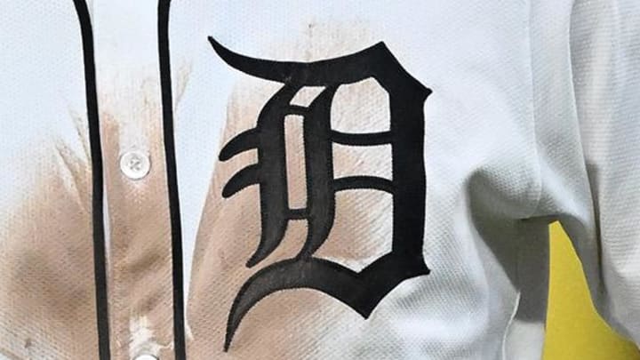 A Detroit Tigers gothic D logo on the front of its white home jersey.