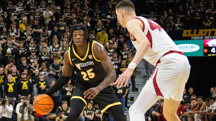 Jan. 18,  2025; Columbia, Missouri, USA; Missouri Tigers forward Mark Mitchell (25) looks to dribble past Zvonimir Ivišić (44) of the Arkansas Razorbacks during a game at Mizzou Arena. 