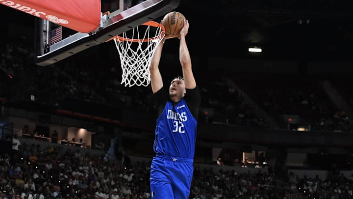 Jul 12, 2025; Las Vegas, NV, USA; Dallas Mavericks forward Cooper Flagg (32) dunks against the San Antonio Spurs in the fourth quarter of their game at Thomas & Mack Center. Mandatory Credit: Candice Ward-Imagn Images
