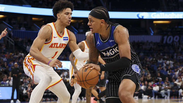 Apr 1, 2026; Orlando, Florida, USA; Orlando Magic forward Paolo Banchero (5) is guarded by Atlanta Hawks forward Jalen Johnson (1) in the third quarter at Kia Center. Mandatory Credit: Nathan Ray Seebeck-Imagn Images