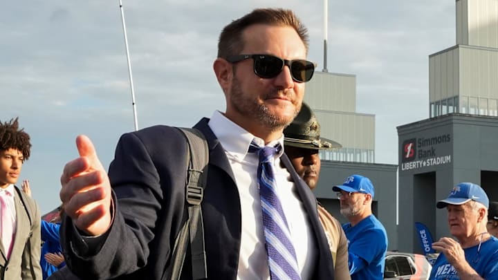 Memphis' head coach Ryan Silverfield walks over to high five a fan during the “Tiger Walk” into the stadium before the game between USF and Memphis at Simmons Bank Liberty Stadium in Memphis, Tenn., on October 25, 2025.