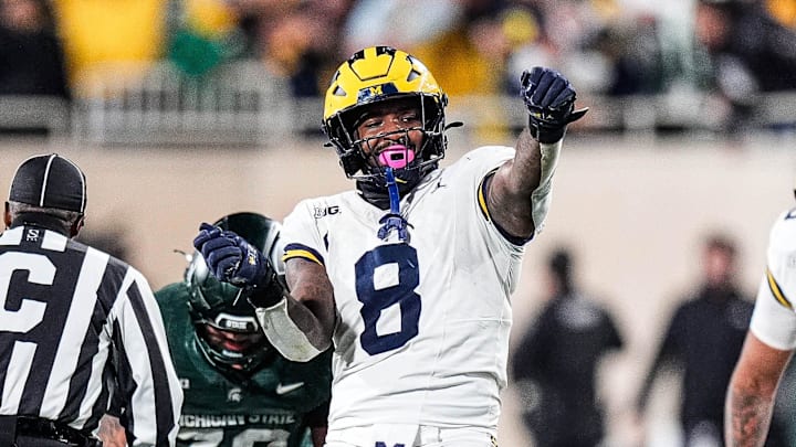 Michigan edge Derrick Moore (8) celebrates a sack against Michigan State quarterback Alessio Milivojevic (11) during the second half at Spartan Stadium in East Lansing on Saturday, October 25, 2025.