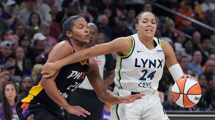 Sep 26, 2025; Phoenix, Arizona, USA; Minnesota Lynx forward Napheesa Collier (24) shields the ball from Phoenix Mercury forward Alyssa Thomas (25) during game three of the second round for the 2025 WNBA Playoffs at PHX Arena. Mandatory Credit: Rick Scuteri-Imagn Images
