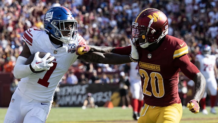Sep 15, 2024; Landover, Maryland, USA; New York Giants wide receiver Malik Nabers (1) stiff arms Washington Commanders safety Quan Martin (20) in the second half at Commanders Field. Mandatory Credit: Luke Johnson-Imagn Images

