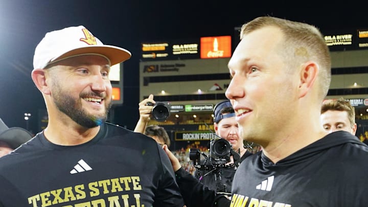 Sep 13, 2025; Tempe, Arizona, USA; Texas State Bobcats head coach G. J. Kinne and Arizona State Sun Devils head coach Kenny Dillingham meet after the game between Arizona State Sun Devils and Texas State Bobcats. Mandatory Credit: Arianna Grainey-Imagn Images Sep 13, 2025; Tempe, Arizona, USA; Texas State Bobcats head coach G. J. Kinne and Arizona State Sun Devils head coach Kenny Dillingham meet after the game between Arizona State Sun Devils and Texas State Bobcats. Mandatory Credit: Arianna Grainey-Imagn Images