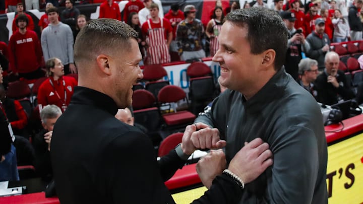 Dec 6, 2025; Raleigh, North Carolina, USA; UNC Asheville Bulldogs head coach Mike Morrell meets with NC State Wolfpack head coach Will Wade before the first half of the game at Lenovo Center. Mandatory Credit: Jaylynn Nash-Imagn Images