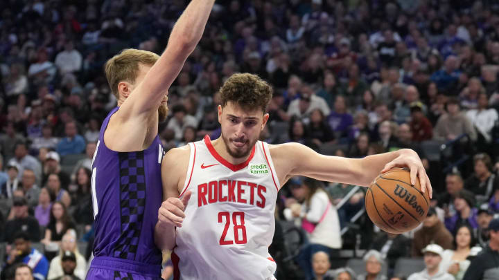 Mar 10, 2024; Sacramento, California, USA; Houston Rockets center Alperen Sengun (28) dribbles against Sacramento Kings forward Domantas Sabonis (left) during the third quarter at Golden 1 Center. Mandatory Credit: Darren Yamashita-USA TODAY Sports