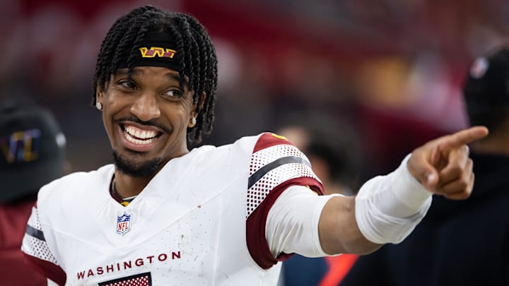 Sep 29, 2024; Glendale, Arizona, USA; Washington Commanders quarterback Jayden Daniels (5) celebrates in the closing seconds of the game against the Arizona Cardinals at State Farm Stadium. Mandatory Credit: Mark J. Rebilas-Imagn Images