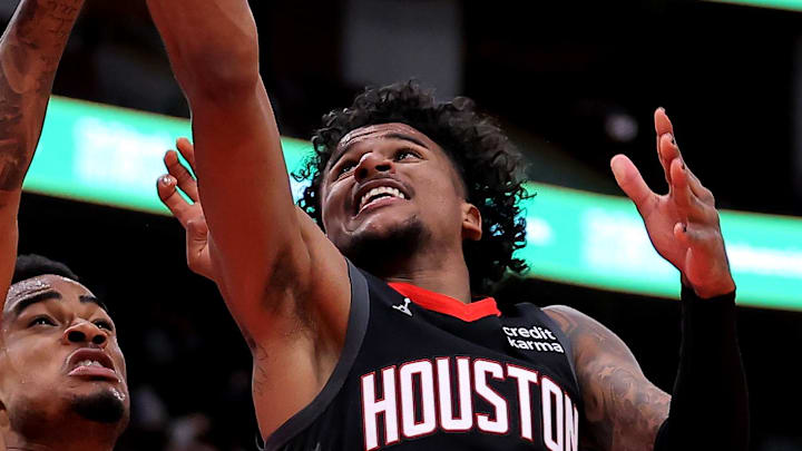 Jan 3, 2024; Houston, Texas, USA; Houston Rockets guard Jalen Green (4) makes a layup against Brooklyn Nets center Nic Claxton (33) during the third quarter at Toyota Center. Mandatory Credit: Erik Williams-Imagn Images