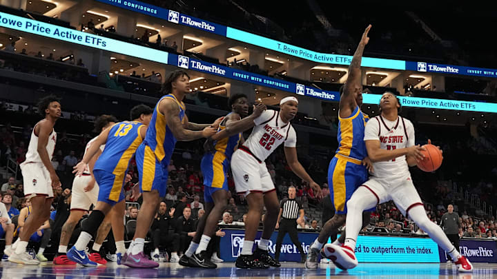 Mar 11, 2026; Charlotte, NC, USA; NC State Wolfpack guard Quadir Copeland (11) drives against the Pittsburgh Panthers during the first half at Spectrum Center. Mandatory Credit: Jim Dedmon-Imagn Images