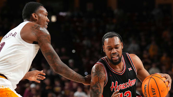 Feb 18, 2025; Tempe, Arizona, USA; Houston Cougars forward J'Wan Roberts (13) drives against Arizona State Sun Devils center Shawn Phillips Jr. (9) during the first half at Desert Financial Arena. Mandatory Credit: Joe Camporeale-Imagn Images