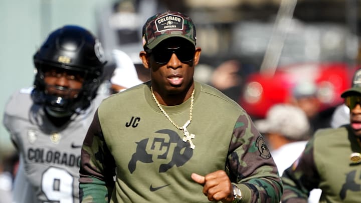 Nov 11, 2023; Boulder, Colorado, USA; Colorado Buffaloes head coach Deion Sanders runs on to the field before the first half against the Arizona Wildcats at Folsom Field. Mandatory Credit: Ron Chenoy-Imagn Images