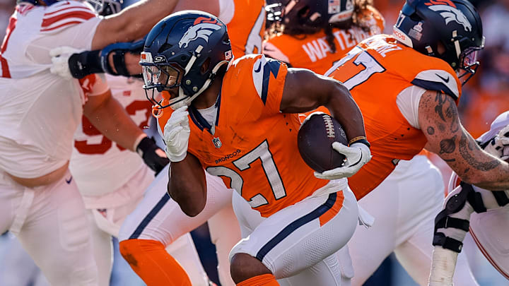 Oct 19, 2025; Denver, Colorado, USA; Denver Broncos running back J.K. Dobbins (27) runs the ball in the third quarter against the New York Giants at Empower Field at Mile High. Mandatory Credit: Isaiah J. Downing-Imagn Images
