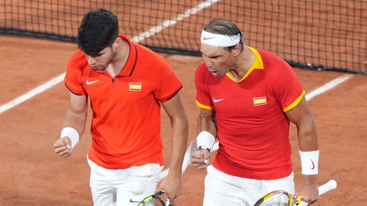 Doubles partners for Spain Carlos Alcaraz and Rafael Nadal react to a point at the 2024 Paris Olympics.