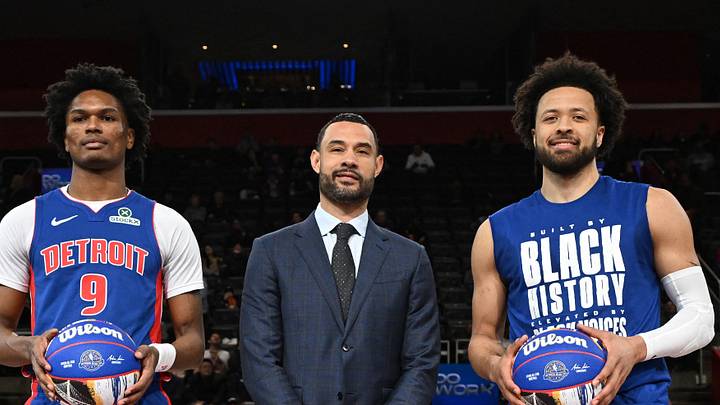 Feb 9, 2025; Detroit, Michigan, USA; Detroit Pistons forward Ausar Thompson (9) and Detroit Pistons guard Cade Cunningham (2) stand at center court with Detroit Pistons President of Basketball Operations Trajan Langdon: Lon Horwedel-Imagn Images