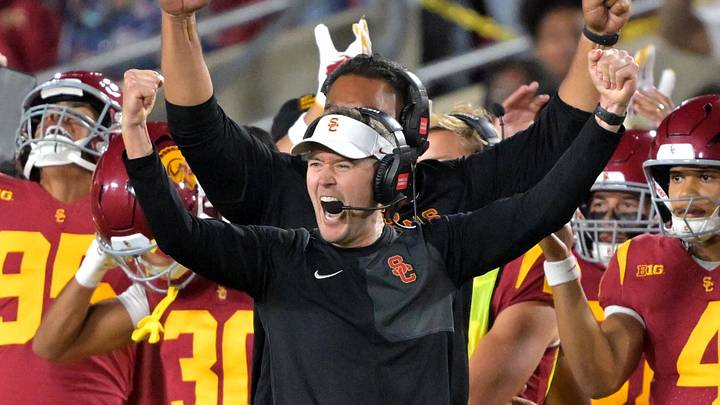 Oct 11, 2025; Los Angeles, California, USA;  USC Trojans head coach Lincoln Riley (wearing white visor) celebrates along with defensive end coach Shaun Nua after kicker Ryon Sayeri (48) hit a 54-yard field goal in the second half against the Michigan Wolverines at United Airlines Field at the Los Angeles Memorial Coliseum. 