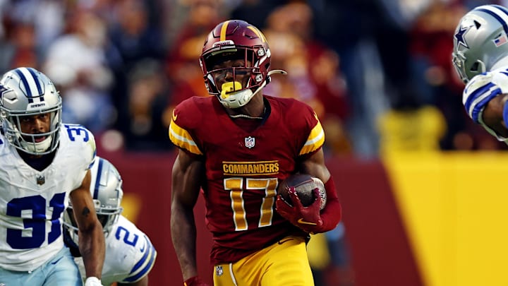 Nov 24, 2024; Landover, Maryland, USA; Washington Commanders wide receiver Terry McLaurin (17) runs for a touchdown against Dallas Cowboys cornerback Josh Butler (31) during the fourth quarter at Northwest Stadium. Mandatory Credit: Peter Casey-Imagn Images