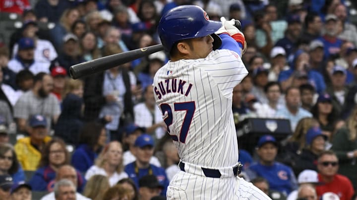 Sep 28, 2024; Chicago, Illinois, USA;  Chicago Cubs outfielder Seiya Suzuki (27) hits a single against the Cincinnati Reds during the first inning at Wrigley Field