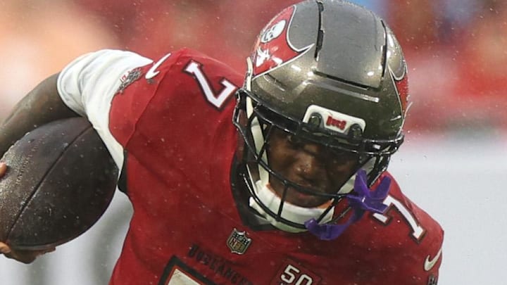 Jan 3, 2026; Tampa, Florida, USA; Tampa Bay Buccaneers running back Bucky Irving (7) runs against Carolina Panthers cornerback Chau Smith-Wade (26) in the first half at Raymond James Stadium. Mandatory Credit: Nathan Ray Seebeck-Imagn Images