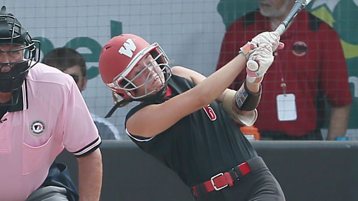 Williamsburg's Alley Gorsh (6) looks at the ball after hitting for a two-RBI against Davenport Assumption during the second inning in the 3A Iowa high school state softball tournament championship at Rogers Sports complex on Friday, July 26, 2024, in Fort Dodge, Iowa.