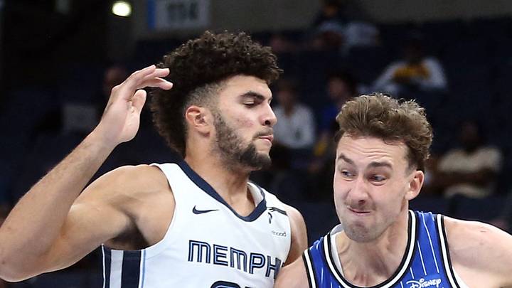 Orlando Magic forward Franz Wagner drives to the basket as Memphis Grizzlies forward Cameron Boozer defends.