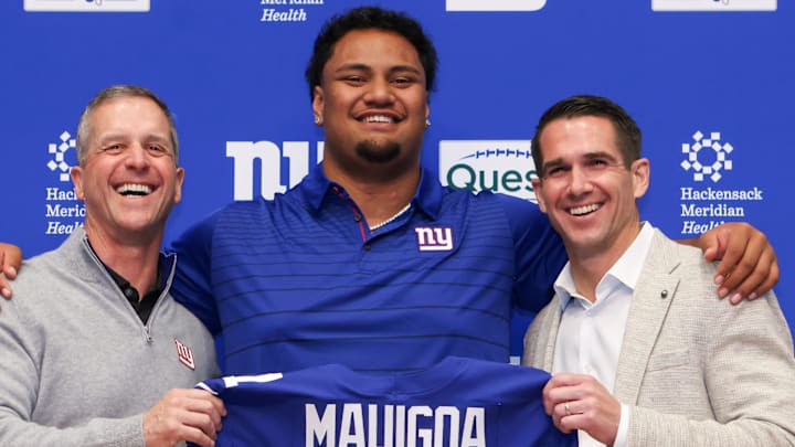 Apr 24, 2026; East Rutherford, NJ, USA; New York Giants draft pick Francis Mauigoa, Head Coach John Harbaugh (left) and General Manager Joe Schoen
