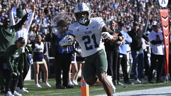 Nov 16, 2024; Annapolis, Maryland, USA;  Tulane Green Wave running back Makhi Hughes (21) scores a touchdown during the first half against the Navy Midshipmen at Navy-Marine Corps Memorial Stadium.