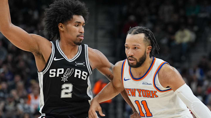 Dec 31, 2025; San Antonio, Texas, USA;  New York Knicks guard Jalen Brunson (11) dribbles against San Antonio Spurs guard Dylan Harper (2) in the second half at Frost Bank Center. Mandatory Credit: Daniel Dunn-Imagn Images