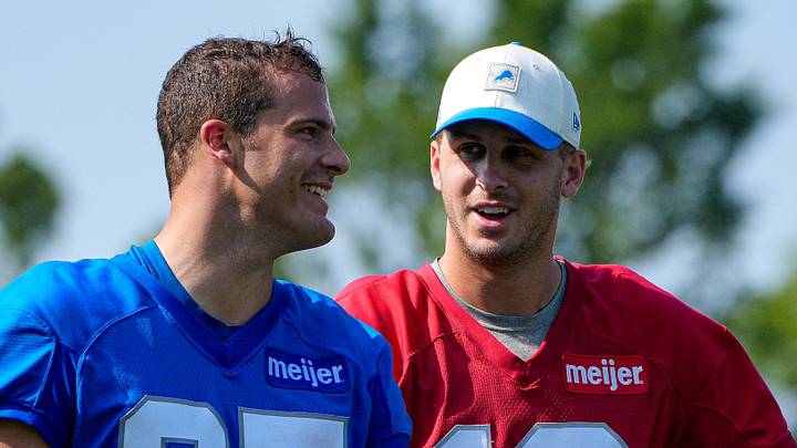 Detroit Lions tight end Sam Laporta (87), left, talks to quarterback Jared Goff (16)  after training camp practice