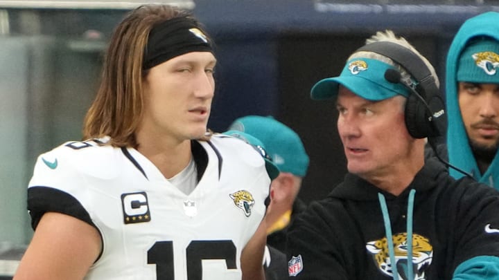 Oct 13, 2024; London, United Kingdom; Jacksonville Jaguars quarterback Trevor Lawrence (16) and quarterbacks coach Mike McCoy watch from the sidelines in the second half during an NFL International Series game Chicago Bears atTottenham Hotspur Stadium. Mandatory Credit: Kirby Lee-Imagn Images