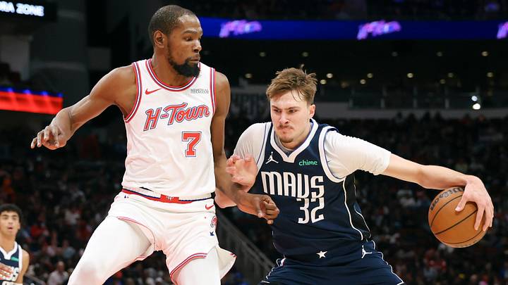 Jan 31, 2026; Houston, Texas, USA; Dallas Mavericks forward Cooper Flagg (32) drives with the ball as Houston Rockets forward Kevin Durant (7) defends during the third quarter at Toyota Center. Mandatory Credit: Troy Taormina-Imagn Images