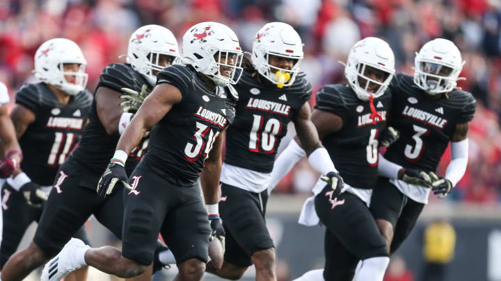 Louisville Cardinals linebacker TJ Quinn (34) holds the ball after making an interception against Virginia Tech as the Cards rolled past the Hokies 34-3 Saturday. Nov.4, 2023.