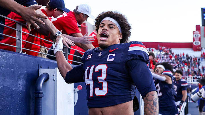 Nov 8, 2025; Tucson, Arizona, USA; Arizona Wildcats defensive back Dalton Johnson (43) celebrates a win against the Kansas Jayhawks with fans at the end of the game at Arizona Stadium. Mandatory Credit: Aryanna Frank-Imagn Images