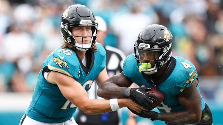 Oct 6, 2024; Jacksonville, Florida, USA; Jacksonville Jaguars quarterback Trevor Lawrence (16) hands off to running back Tank Bigsby (4) against the Indianapolis Colts in the fourth quarter at EverBank Stadium. Mandatory Credit: Nathan Ray Seebeck-Imagn Images