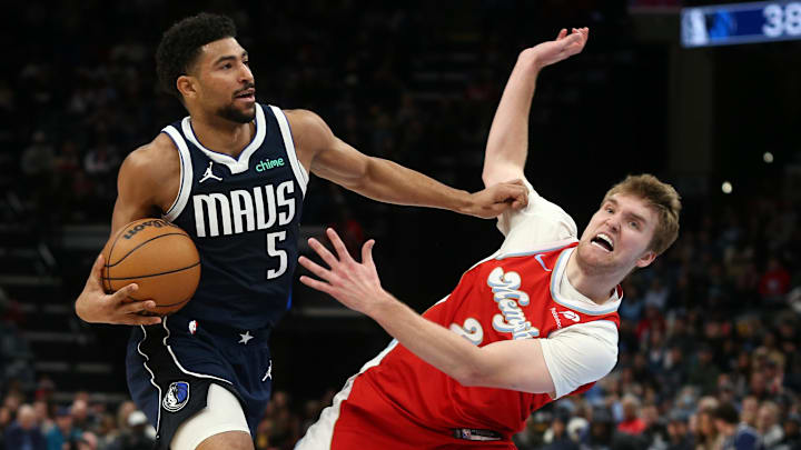 Jan 6, 2025; Memphis, Tennessee, USA; Dallas Mavericks guard Quentin Grimes (5) drives to the basket as Memphis Grizzlies guard Cam Spencer (24) defends during the second quarter at FedExForum. Mandatory Credit: Petre Thomas-Imagn Images