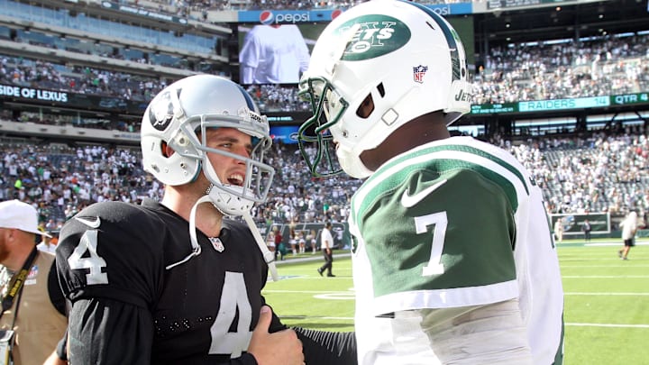 Sep 7, 2014; East Rutherford, NJ, USA; Oakland Raiders quarterback Derek Carr (4) and New York Jets quarterback Geno Smith (7) meet at midfield after a game at MetLife Stadium. The Jets defeated the Raiders 19-14. Mandatory Credit: Brad Penner-Imagn Images