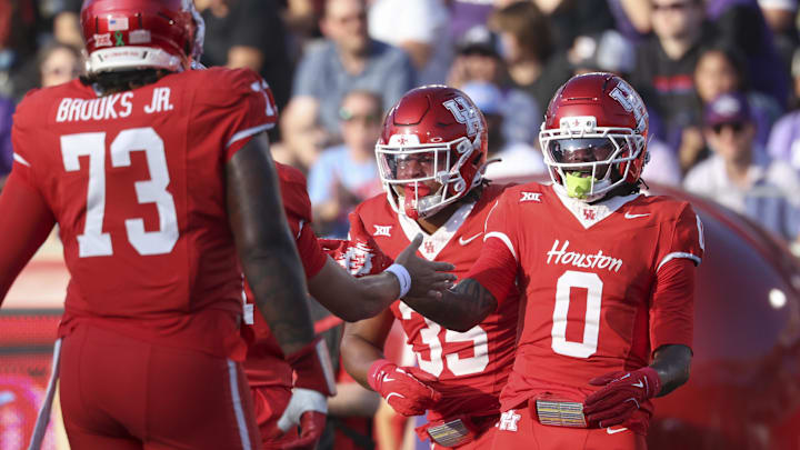 Nov 22, 2025; Houston, Texas, USA; Houston Cougars wide receiver Amare Thomas (0) celebrates after a touchdown reception during the second quarter against the TCU Horned Frogs at TDECU Stadium. Mandatory Credit: Troy Taormina-Imagn Images