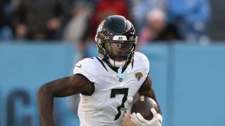 Nov 30, 2025; Nashville, Tennessee, USA;  Jacksonville Jaguars wide receiver Brian Thomas Jr. (7) runs with the ball after a made catch against the Tennessee Titans during the second half at Nissan Stadium. Mandatory Credit: Steve Roberts-Imagn Images
