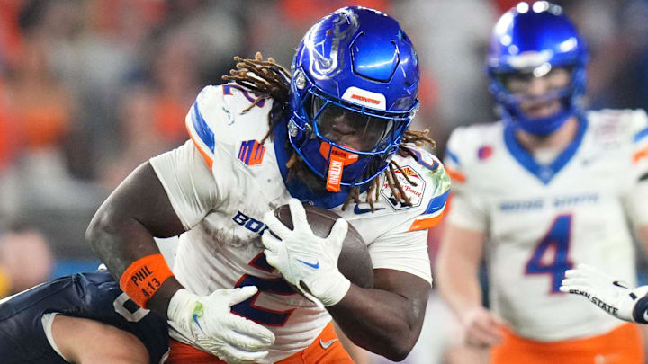 Dec 31, 2024; Glendale, AZ, US; Boise State Broncos running back Ashton Jeanty (2) tries to break past Penn State Nittany Lions linebacker Dominic DeLuca (0) during their Vrbo Fiesta Bowl matchup at State Farm Stadium.