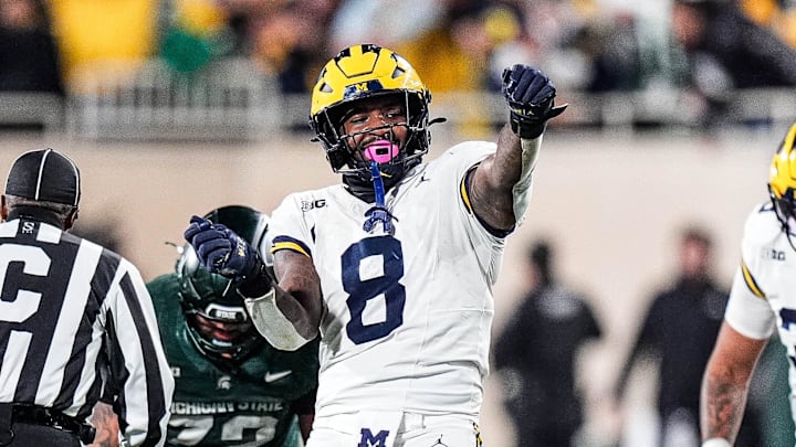 Michigan edge Derrick Moore (8) celebrates a sack against Michigan State quarterback Alessio Milivojevic (11) during the second half at Spartan Stadium in East Lansing on Saturday, October 25, 2025.