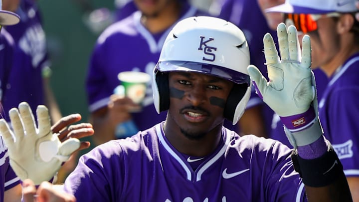 Kansas State's Dondreone Kennedy celebrates with teammates in the dugout following a home run. The Wildcats dominated SIUE 20-7 Sunday.