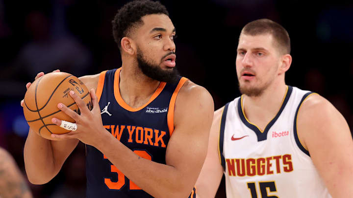 Jan 29, 2025; New York, New York, USA; New York Knicks center Karl-Anthony Towns (32) controls the ball against Denver Nuggets center Nikola Jokic (15) during the third quarter at Madison Square Garden. Mandatory Credit: Brad Penner-Imagn Images
