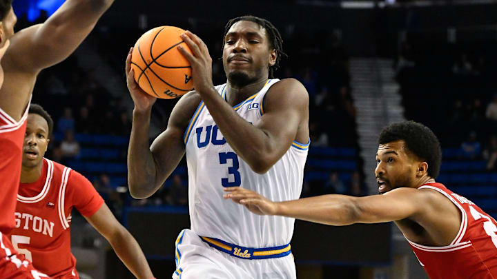Nov 11, 2024; Los Angeles, California, USA; UCLA Bruins guard Eric Dailey Jr. (3) drives to the basket between Boston University Terriers forward Malcolm Chimezie (3) and guard Miles Brewster (24) during the second half at Pauley Pavilion presented by Wescom. Mandatory Credit: Robert Hanashiro-Imagn Images Nov 11, 2024; Los Angeles, California, USA; UCLA Bruins guard Eric Dailey Jr. (3) drives to the basket between Boston University Terriers forward Malcolm Chimezie (3) and guard Miles Brewster (24) during the second half at Pauley Pavilion presented by Wescom. Mandatory Credit: Robert Hanashiro-Imagn Images