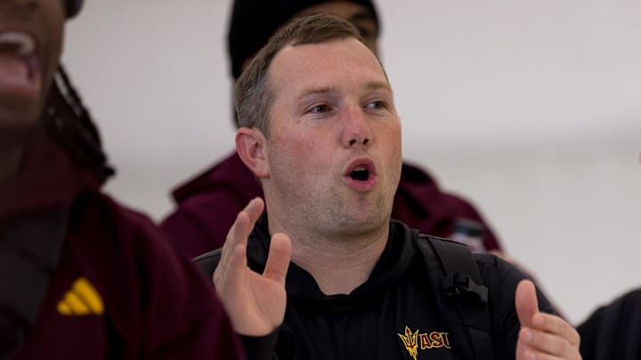 Arizona State head football coach Kenny Dillingham watches folklórico dancers perform as they arrive at the Atlantic FBO Hangar in El Paso, Texas, on Saturday, Dec. 27, 2025, ahead of the Tony the Tiger Sun Bowl.