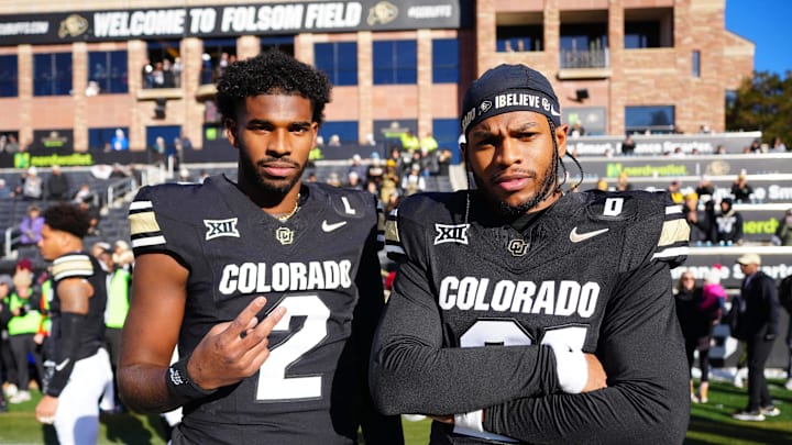 Nov 29, 2024; Boulder, Colorado, USA; Colorado Buffaloes quarterback Shedeur Sanders (2) and safety Shilo Sanders (21) pose for a photo before the game against the Oklahoma State Cowboys at Folsom Field. 